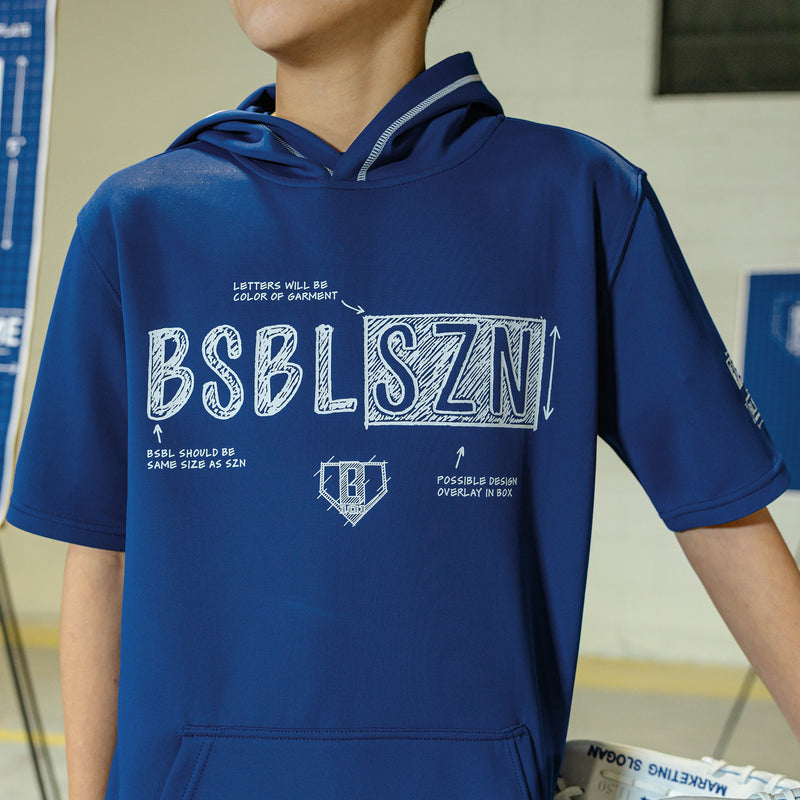Person wearing a navy shorts sleeve blue hoodie with white blueprint 'BSBL SZN' text 