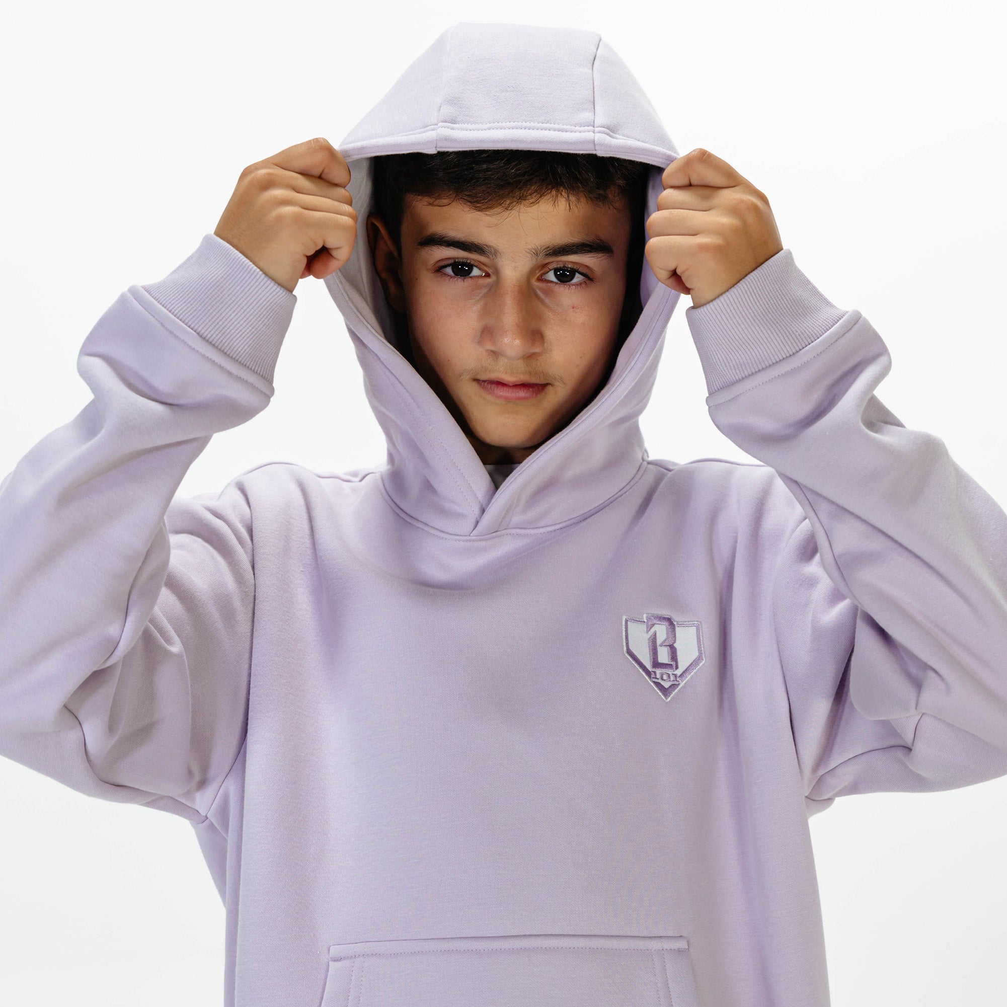 Youth model wearing Purple Baseline hoodie