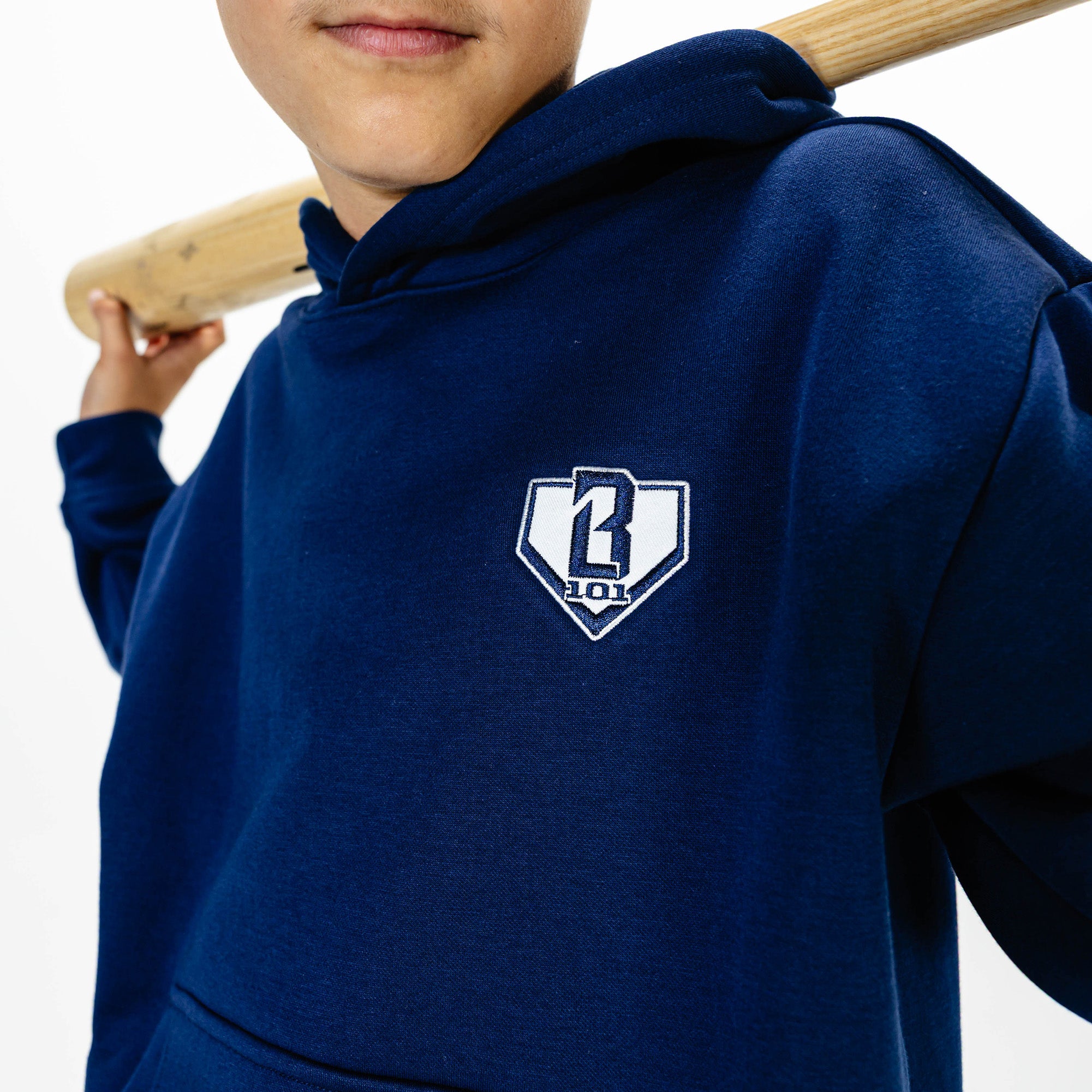Youth model wearing Navy Baseline hoodie