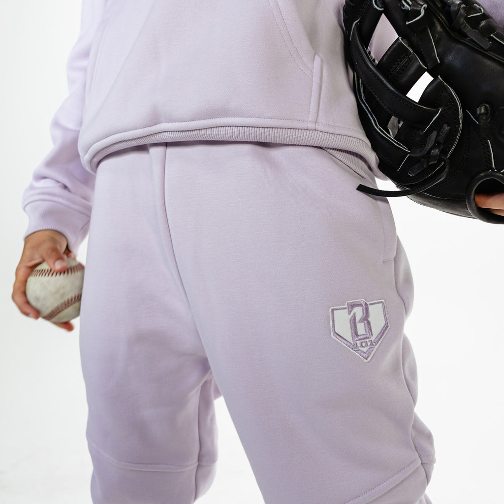 Youth model wearing Purple Baseline joggers