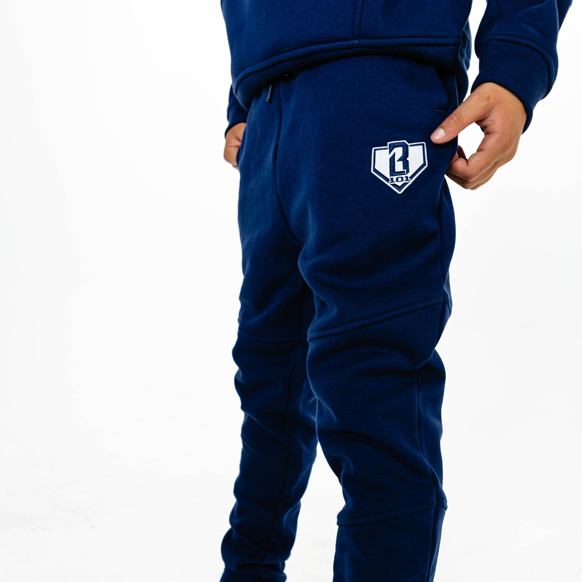 Youth model wearing Navy Baseline joggers