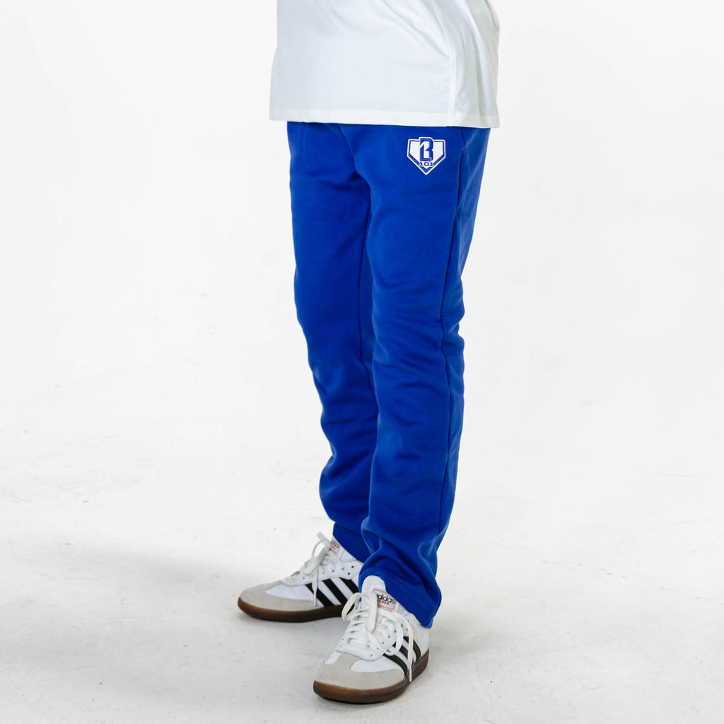Youth model wearing Blue Baseline Straight Leg sweatpants