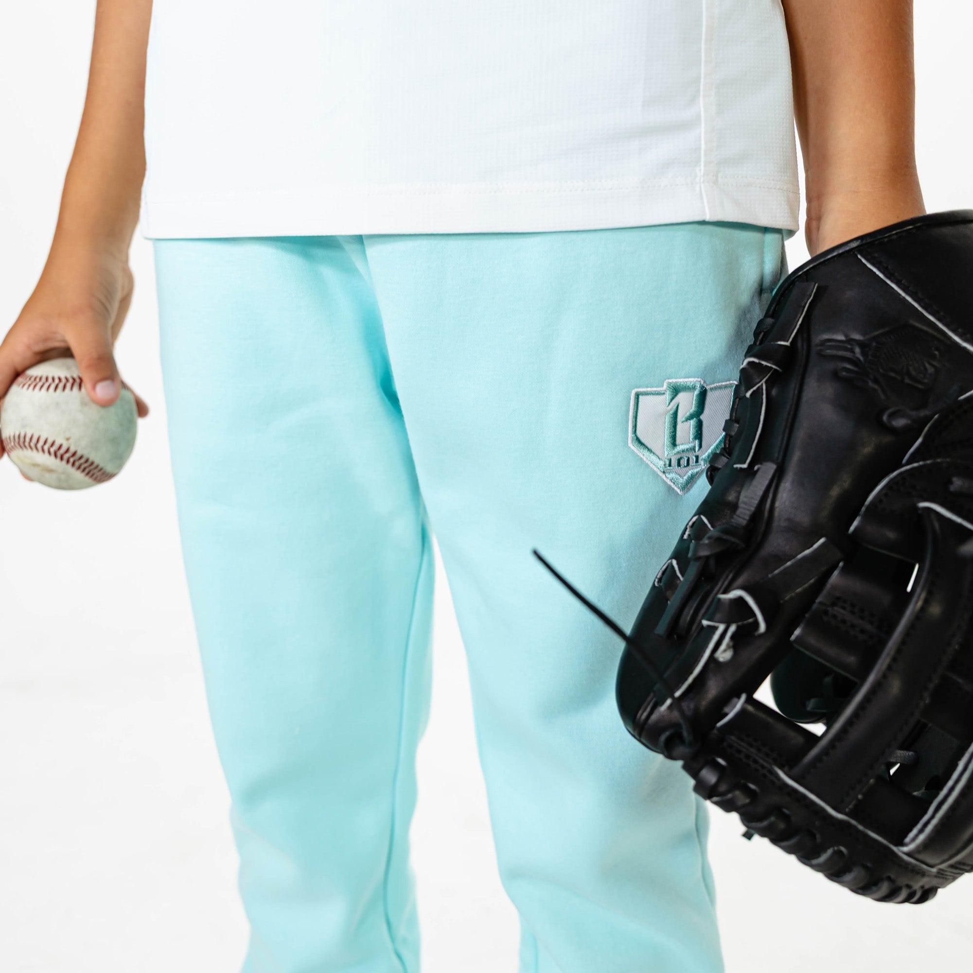 Youth model wearing Blue Baseline Straight Leg sweatpants