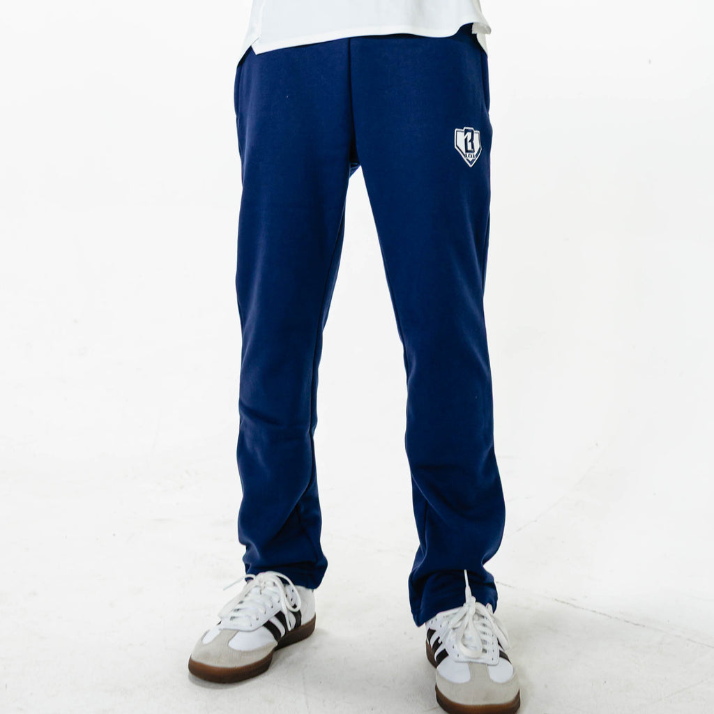Youth model wearing Navy Baseline Straight Leg sweatpants