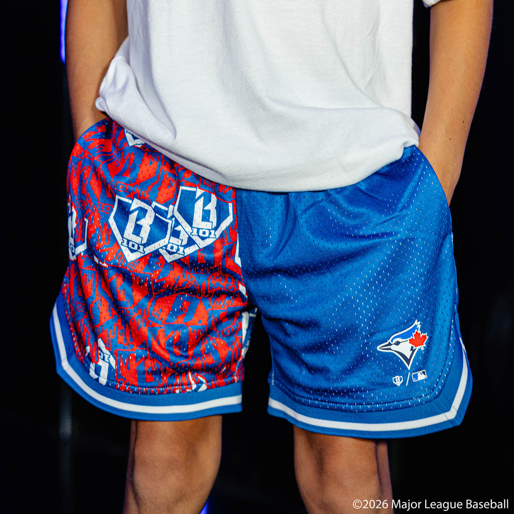 Youth model wearing blue youth shorts with "Toronto Blue Jays Sticker Court" design