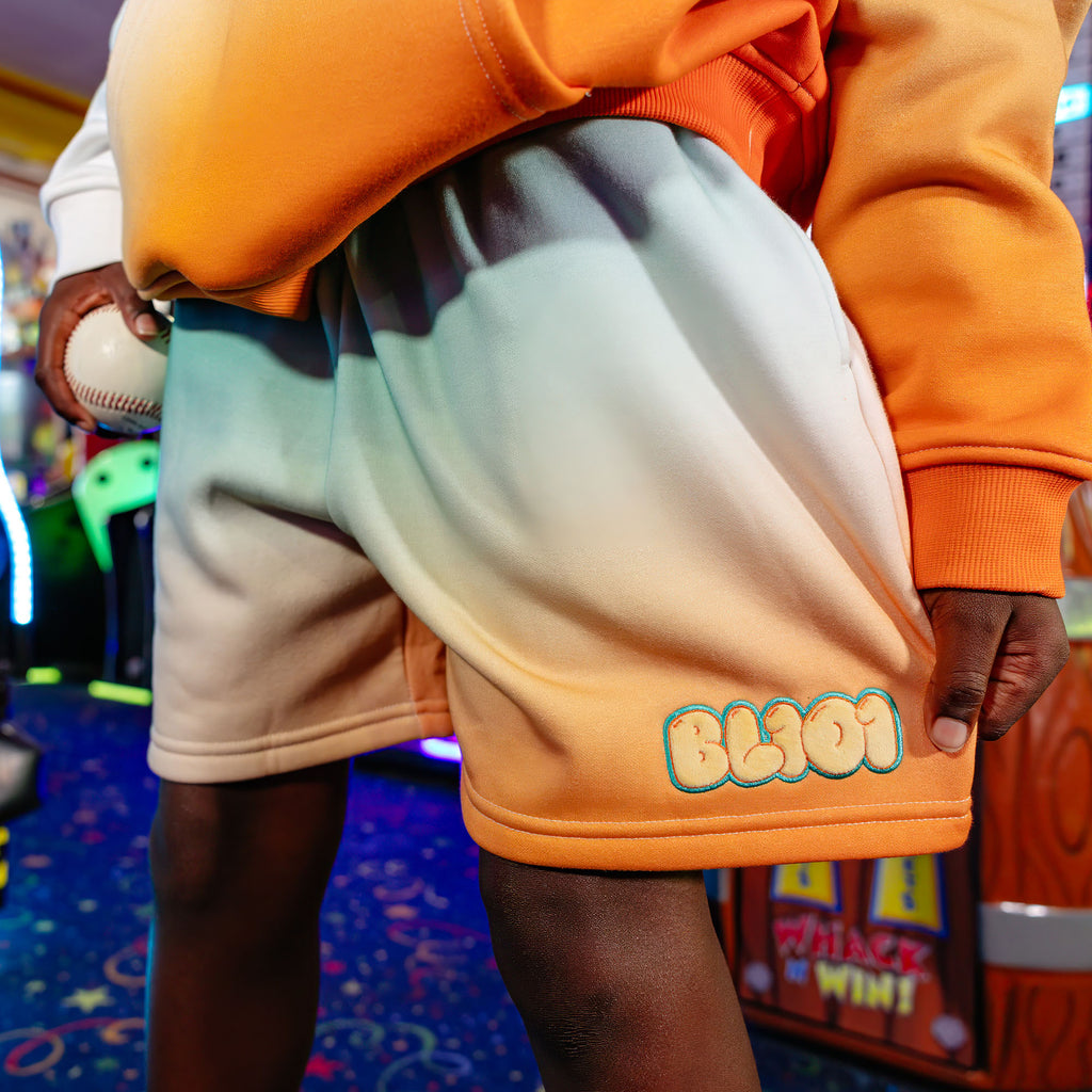 Youth model wearing Cotton Candy Tangerine Freeze youth shorts