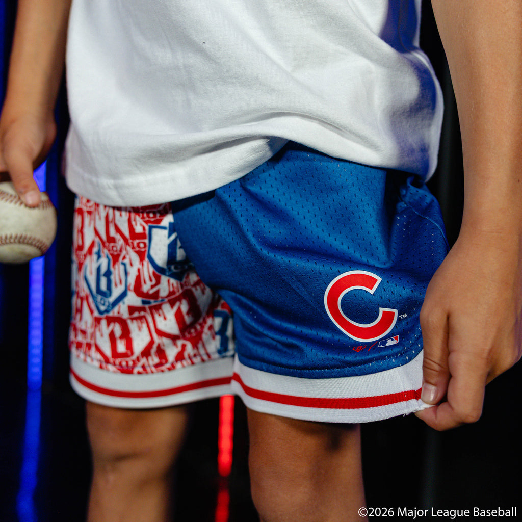 Youth model wearing blue youth shorts with "Chicago Cubs Sticker Court" design