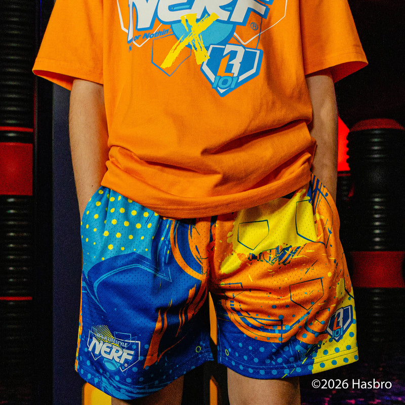 Person wearing an orange t-shirt and colorful shorts with a BL101 and Nerf logo.