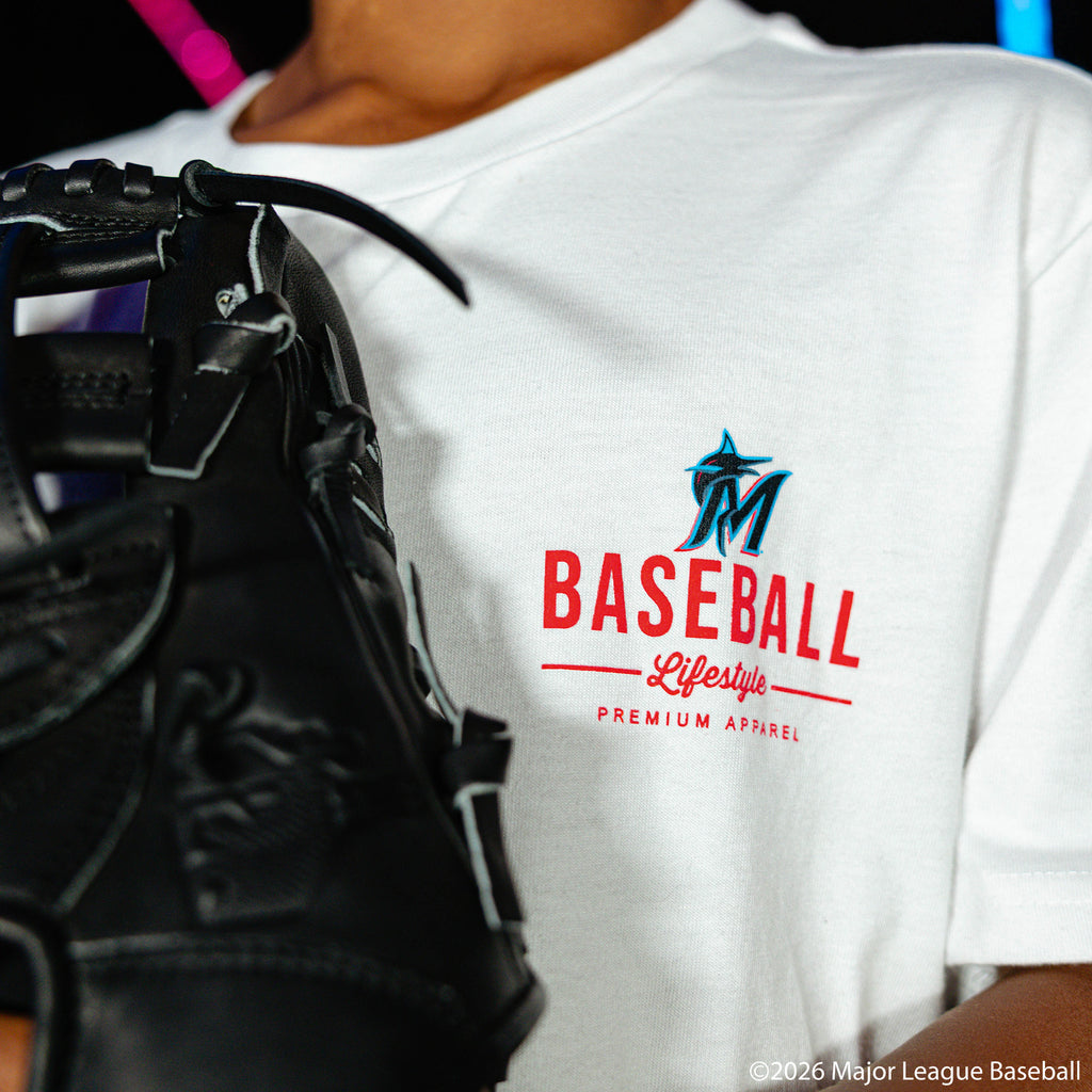 Youth model wearing white youth graphic tee with "Miami Marlins Ice Cream Cap" design