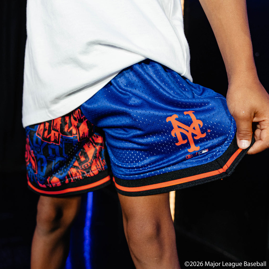 Youth model wearing blue youth shorts with "New York Mets Sticker Court" design