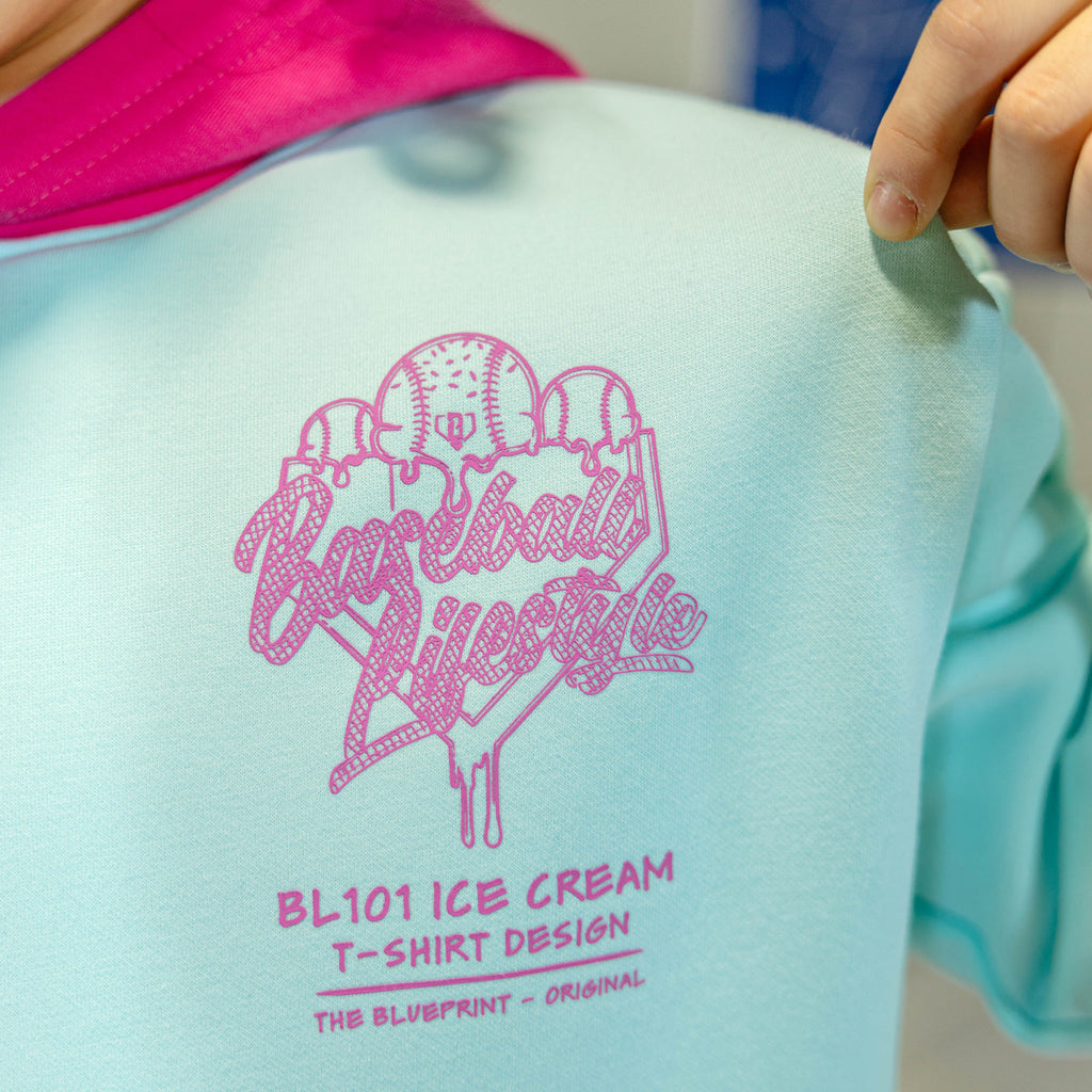 Child in light blue hoodie with pink hood and pink BL101 Ice cream logo
