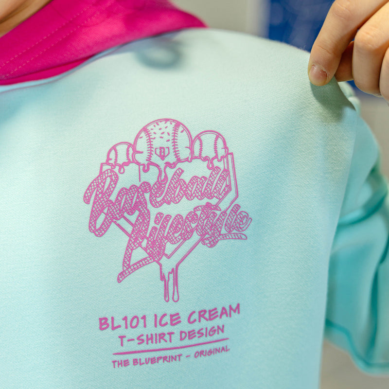 Child in light blue hoodie with pink hood and pink BL101 Ice cream logo