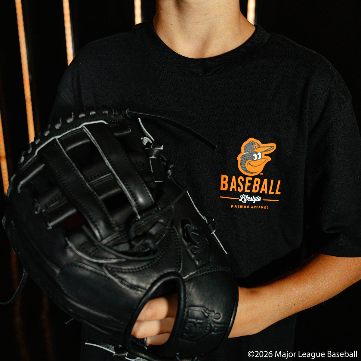 Youth model wearing black youth graphic tee with "Baltimore Orioles Ice Cream Cap" design