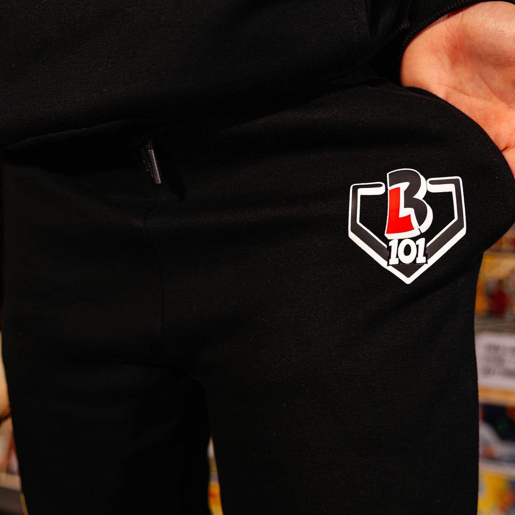 Youth model wearing black youth sweatpants with "Power Hitter" design