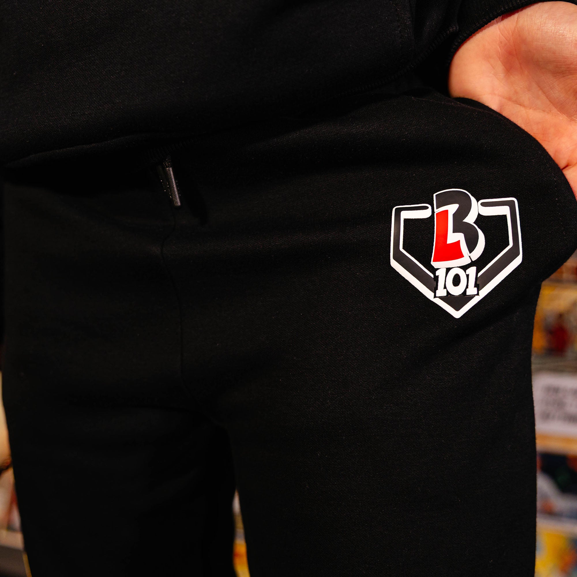 Youth model wearing black youth sweatpants with "Power Hitter" design