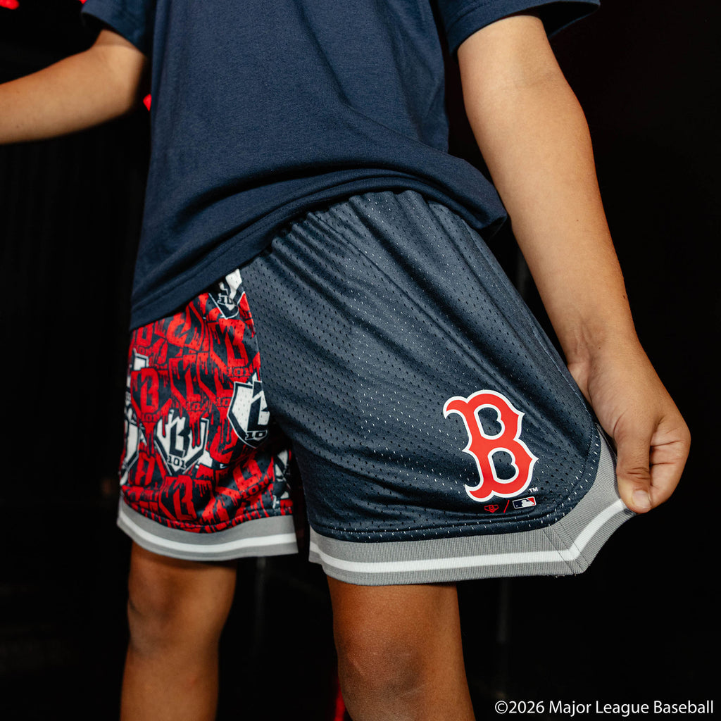 Youth model wearing navy youth shorts with "Boston Red Sox Sticker Court" design