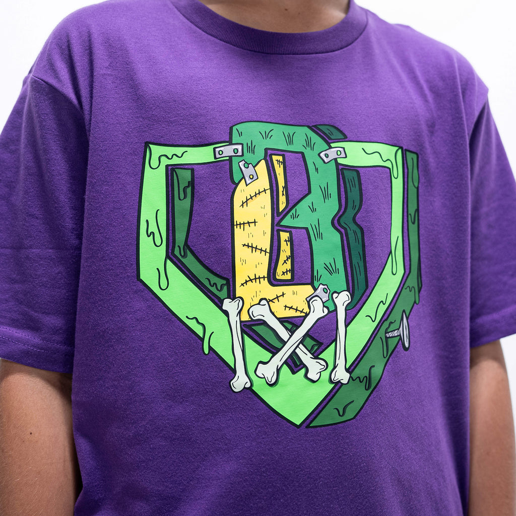 Youth model wearing purple youth graphic tee with "Spooky SZN Stitch" design