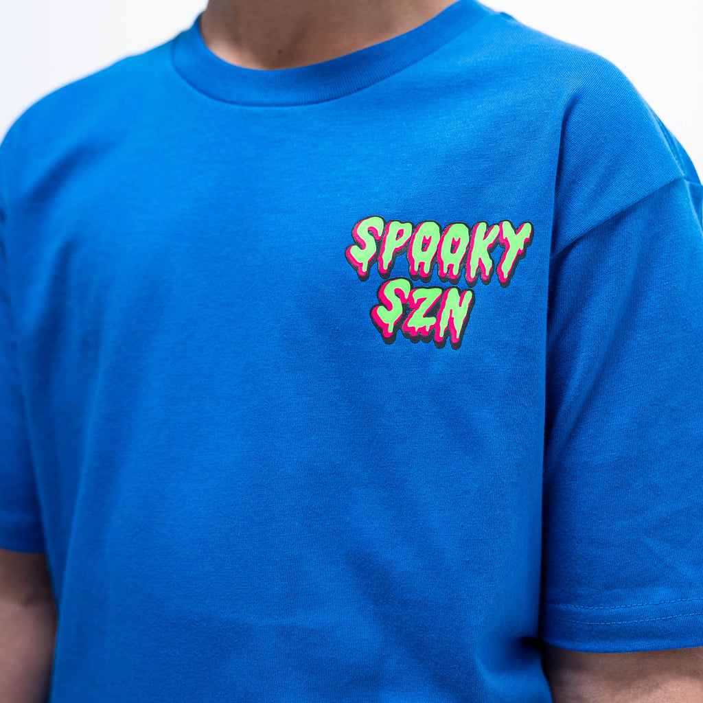 Youth model wearing blue youth graphic tee with "Spooky SZN Waffle" design