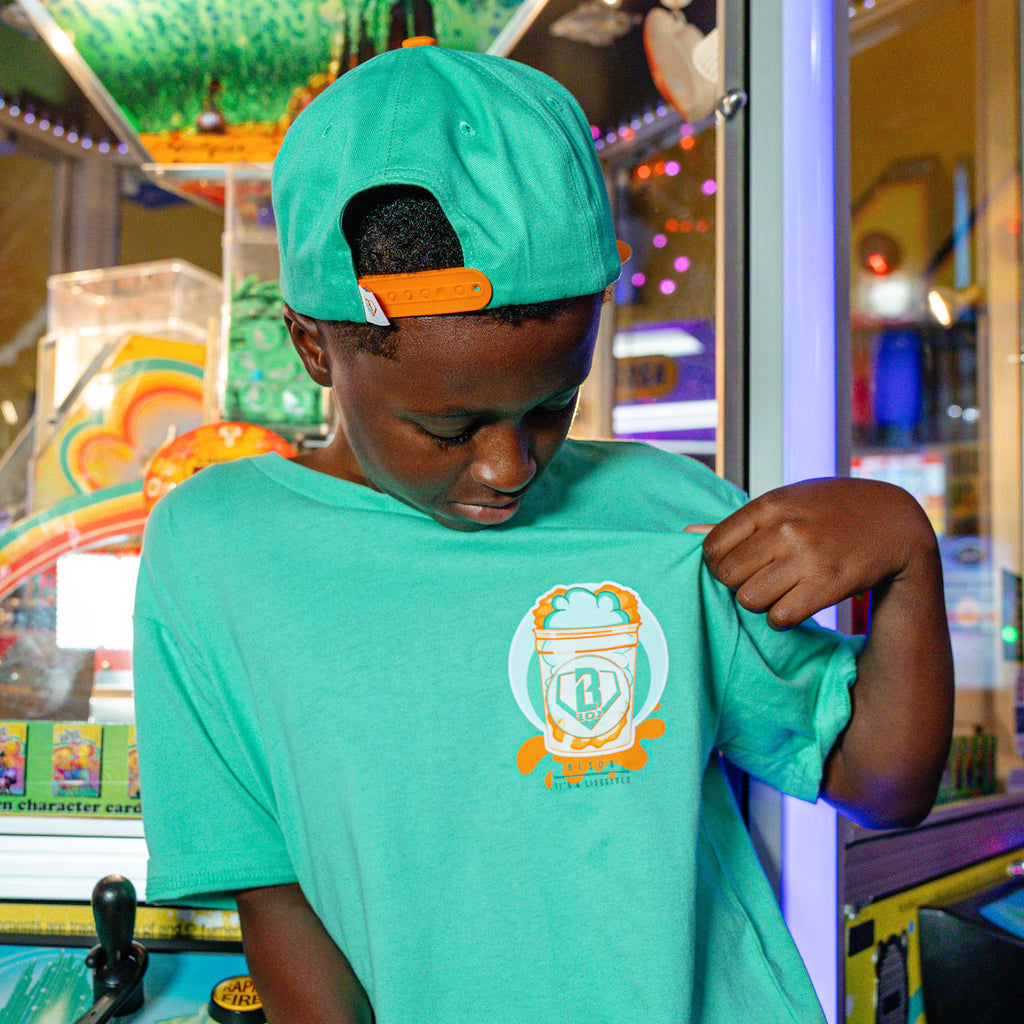 Youth model wearing Sweet Spot Tangerine Freeze youth graphic tee