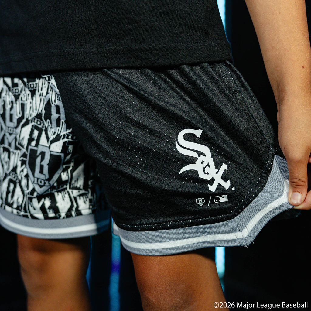 Youth model wearing black youth shorts with "Chicago White Sox Sticker Court" design