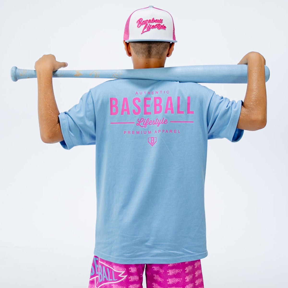 Person wearing a light blue t-shirt with pink text, holding a baseball bat, on a white background