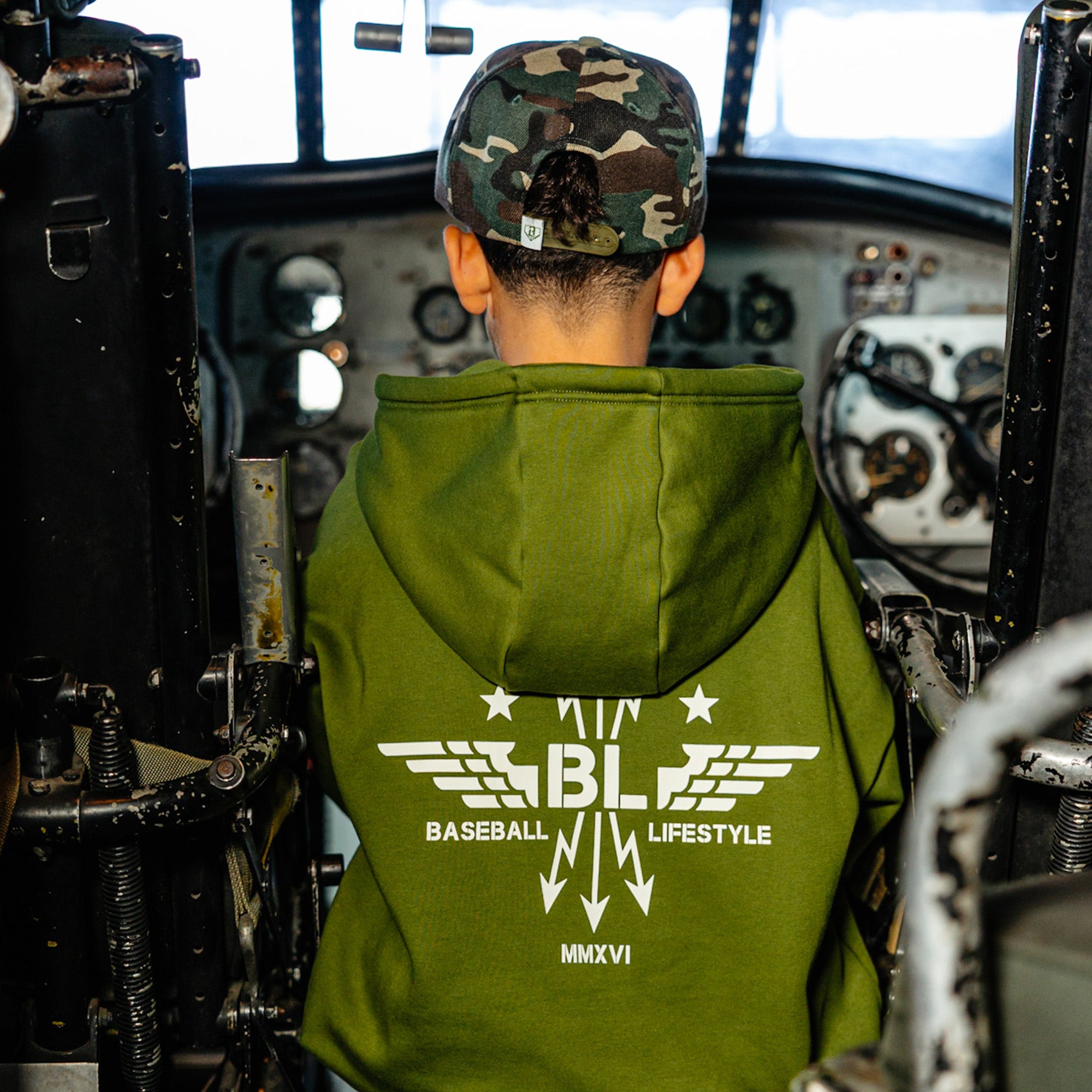 Youth model wearing green Flight Deck Army Green youth hoodie