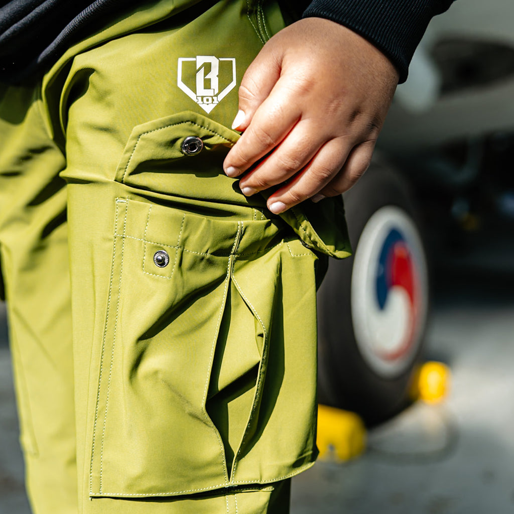 Olive green jogger cargo pants with drawstring waist, zippered pockets, utility cargo pockets, and white BL101 embroidered logo on side