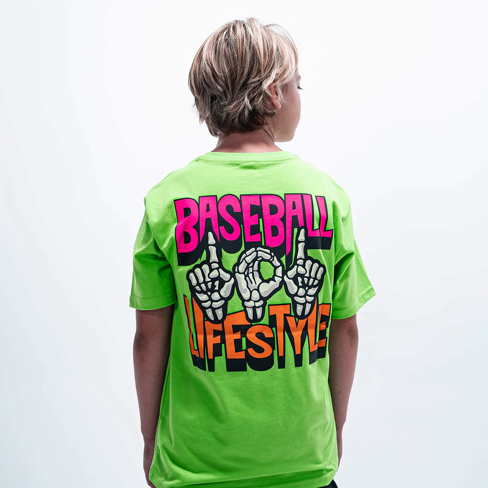 Youth model wearing green youth graphic tee with "101 Skeleton" design
