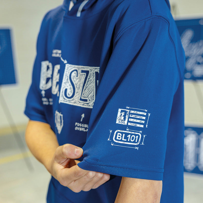 Person wearing a navy shorts sleeve blue hoodie with white blueprint 'BSBL SZN' text 