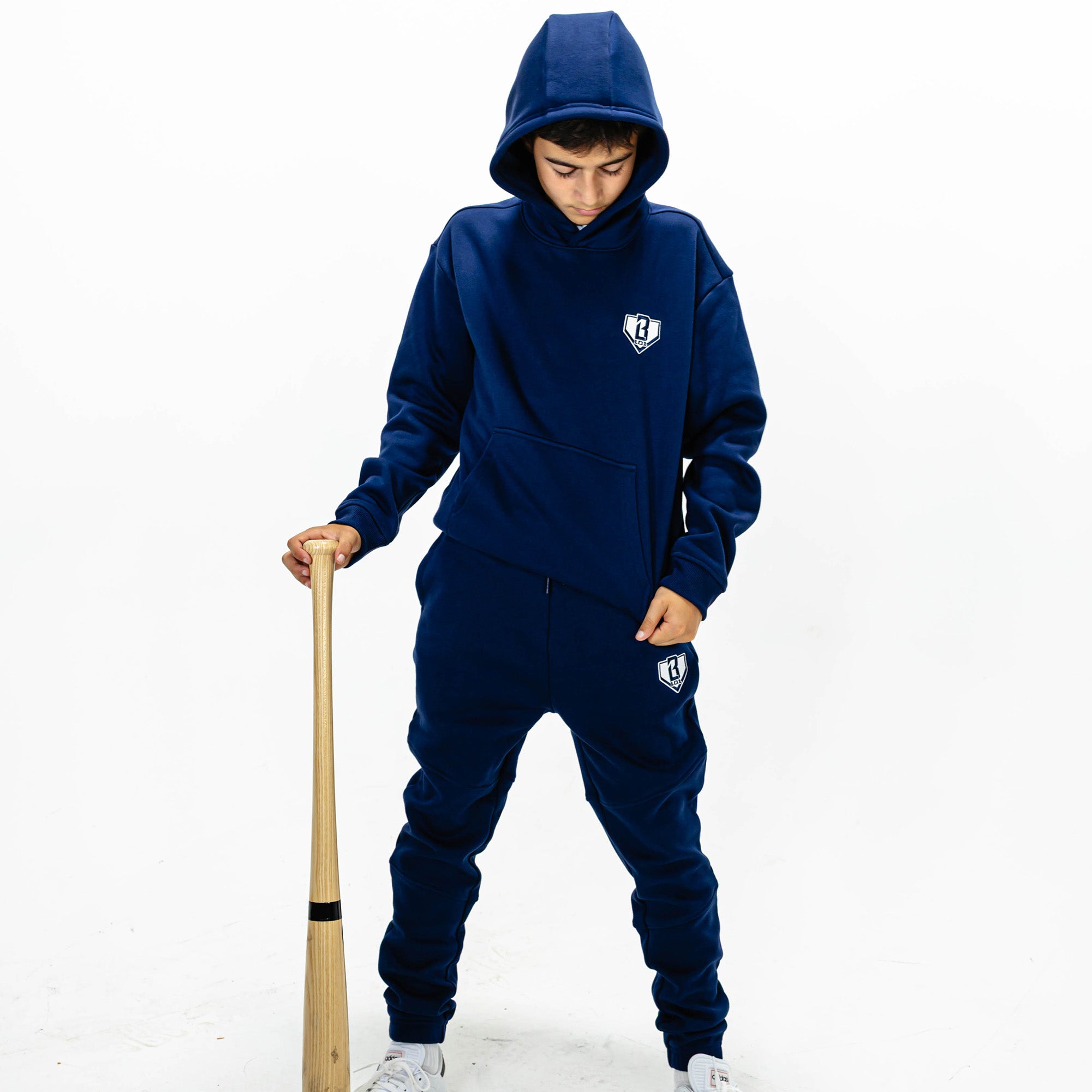 Youth model wearing Navy Baseline hoodie