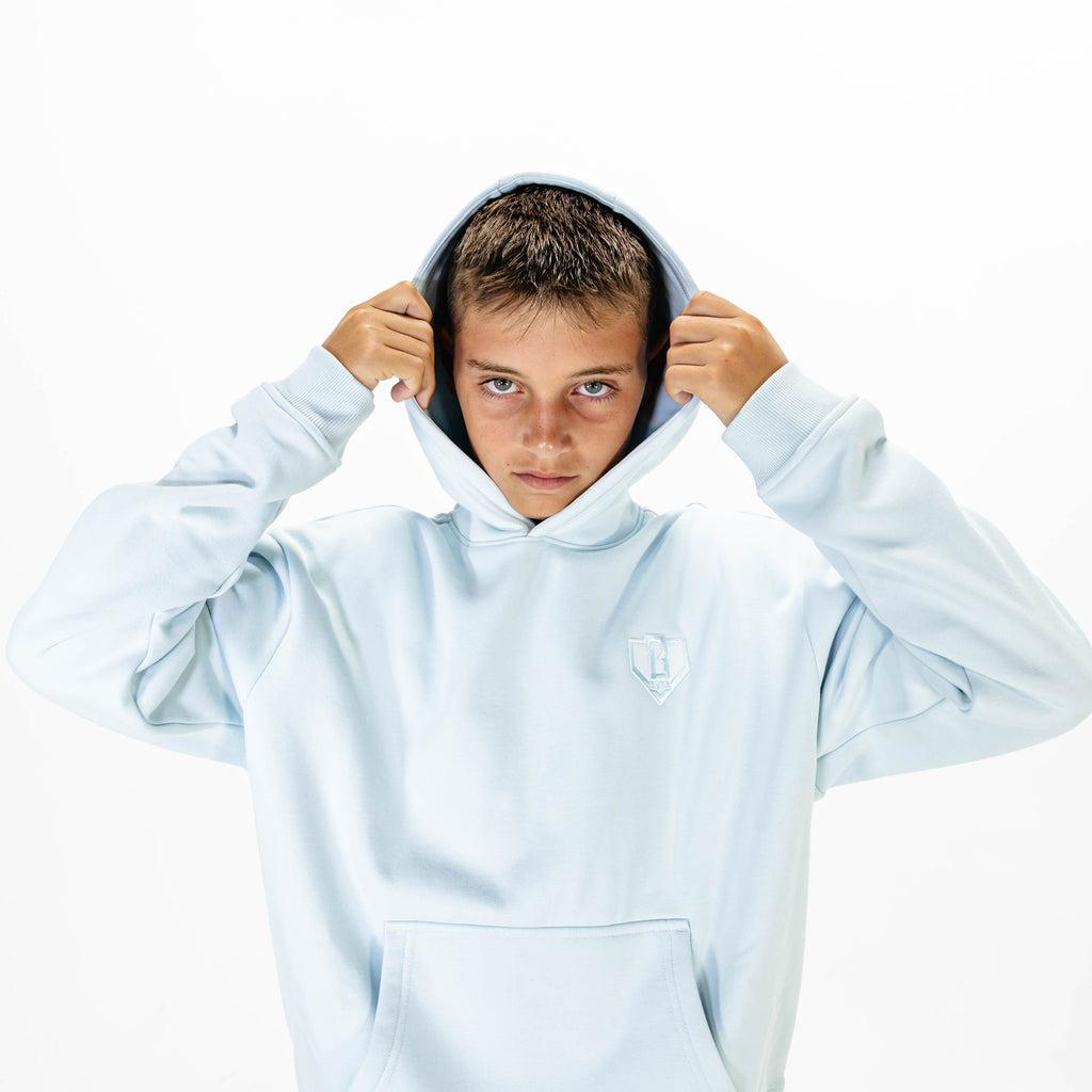Youth model wearing Blue Baseline hoodie