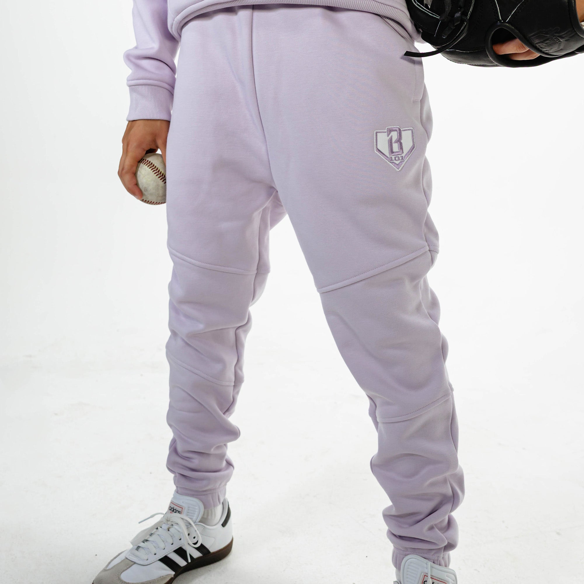 Youth model wearing Purple Baseline joggers