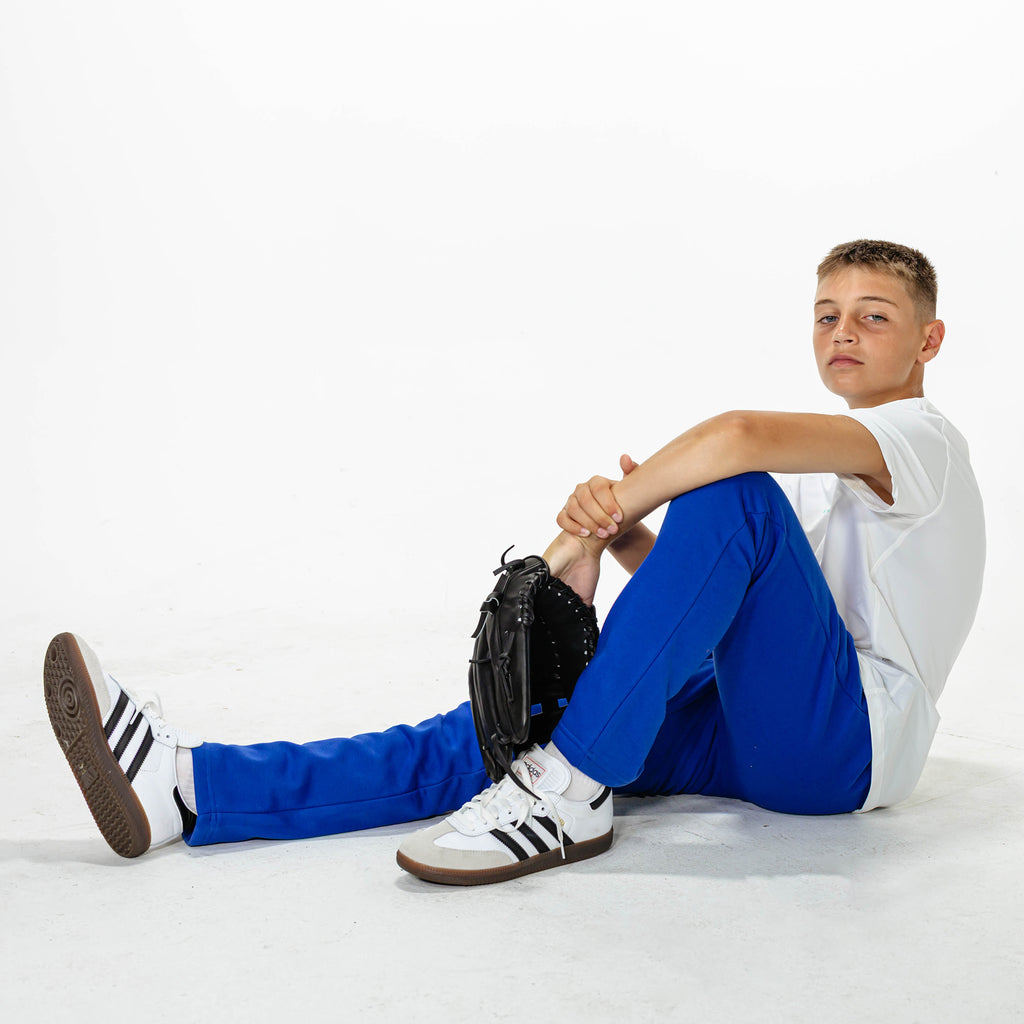 Youth model wearing Blue Baseline Straight Leg sweatpants