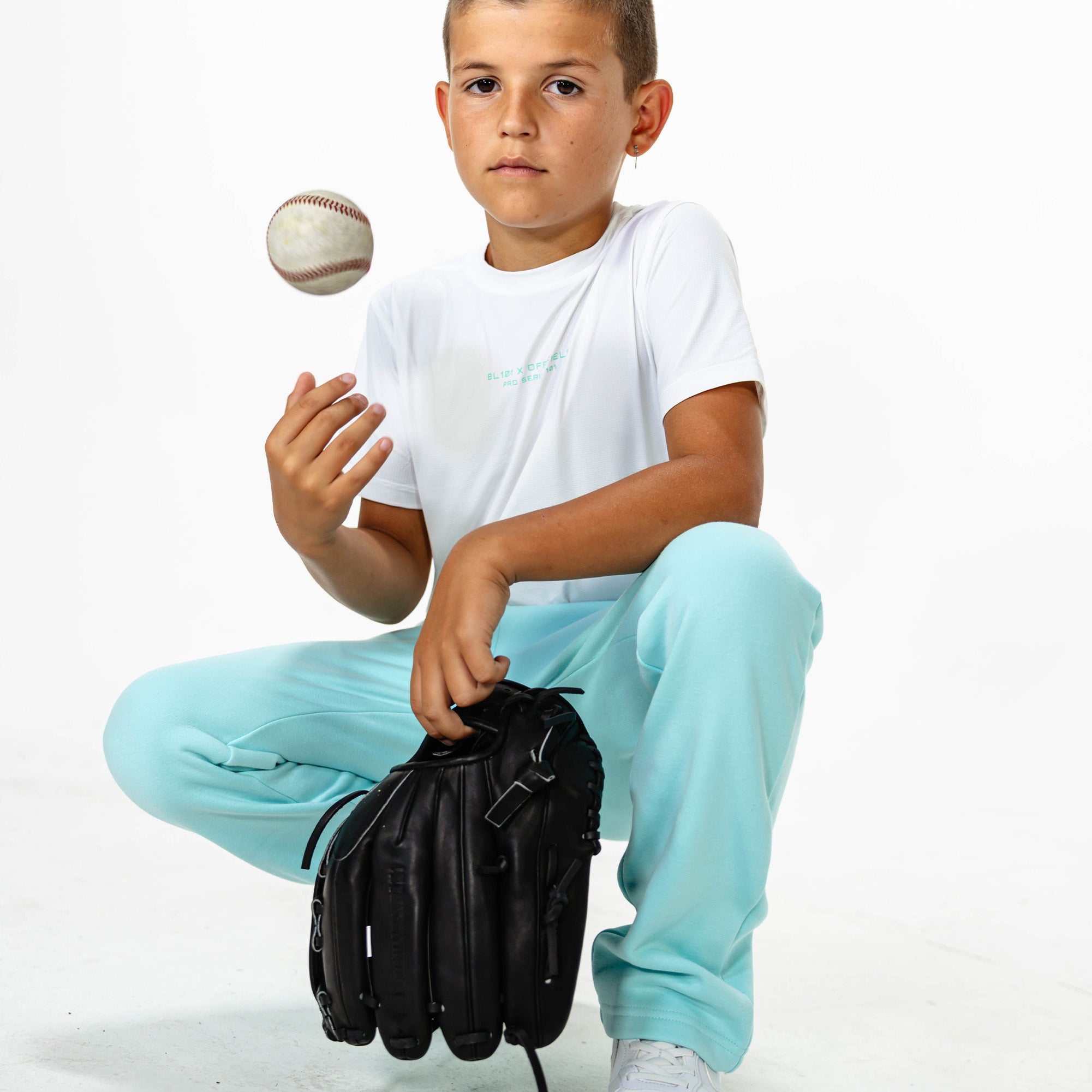 Youth model wearing Blue Baseline Straight Leg sweatpants