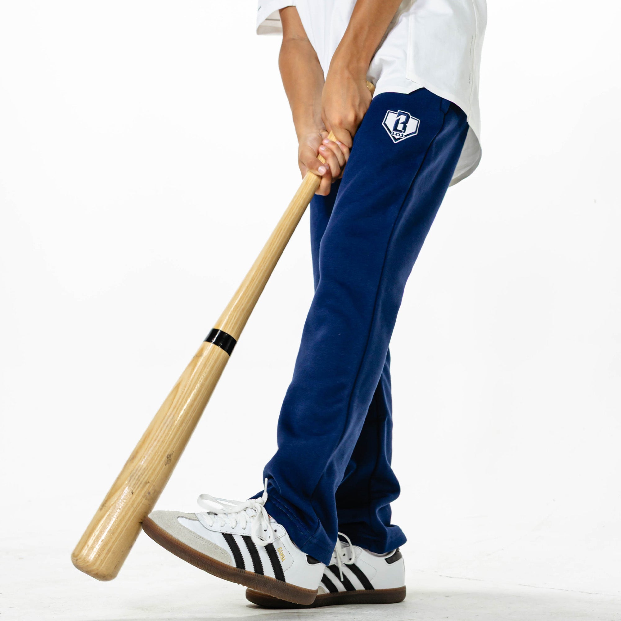 Youth model wearing Navy Baseline Straight Leg sweatpants