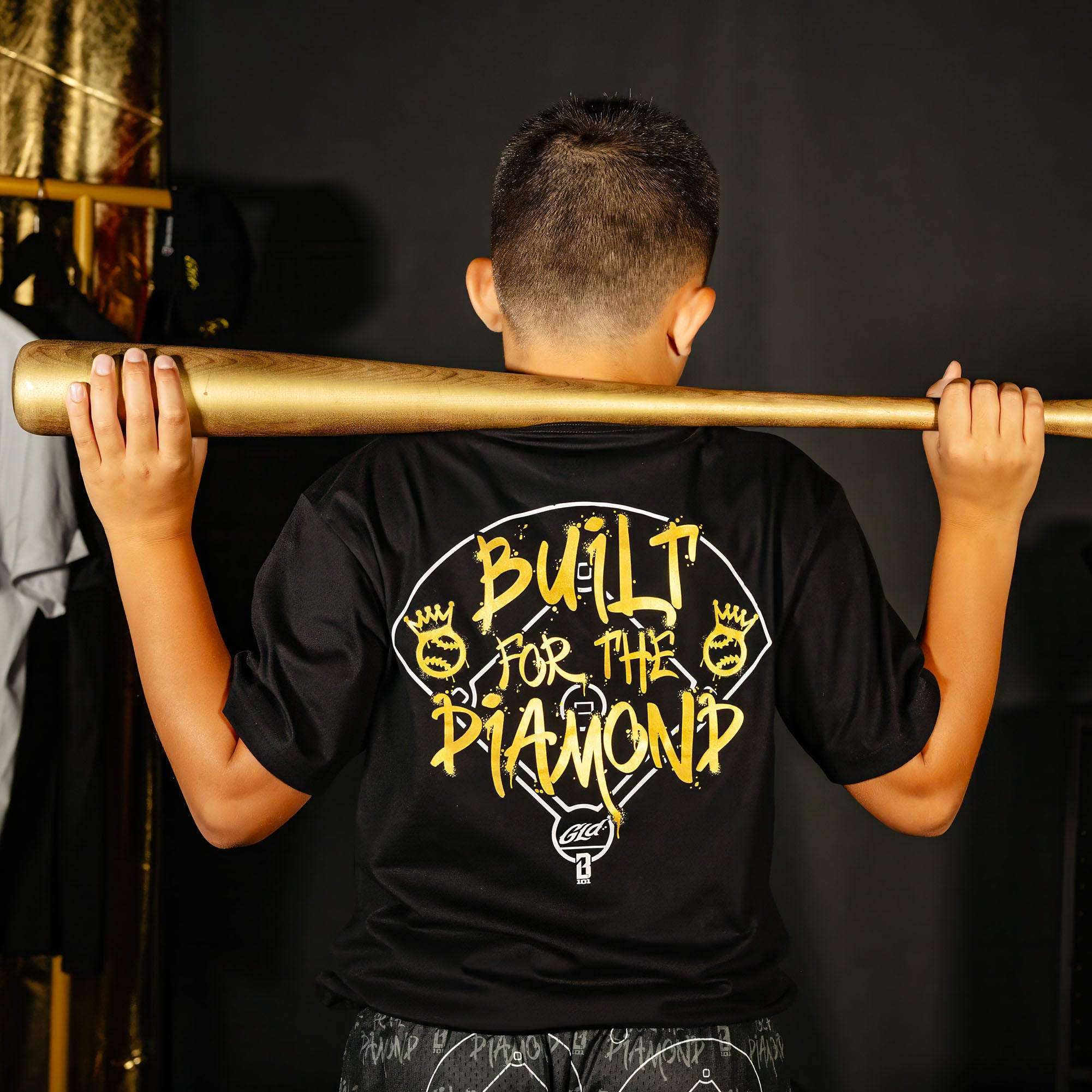 Youth model wearing black youth graphic tee with "Built For The Diamond" design