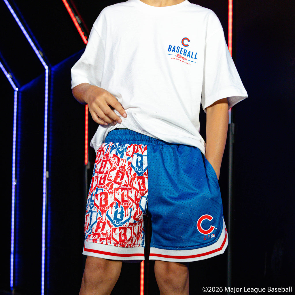 Youth model wearing blue youth shorts with "Chicago Cubs Sticker Court" design