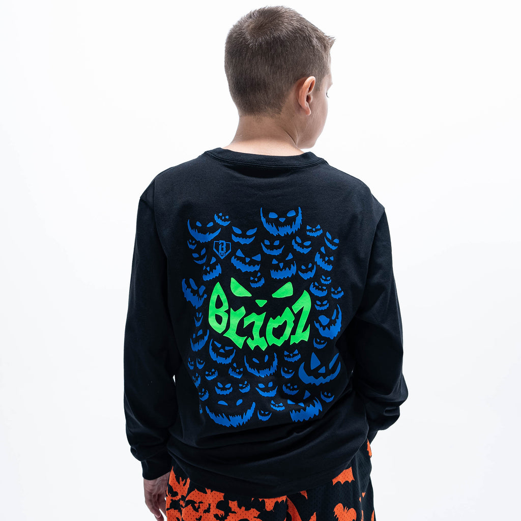 Youth model wearing black youth long sleeve tee with "Jack O' Lantern Team" design