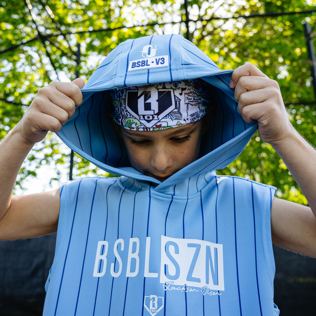 Youth player lifting his hood to reveal the Jackson Olson x BL101 white graphic headband underneath