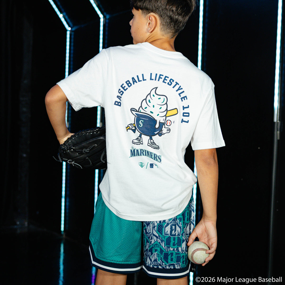 Youth model wearing white youth graphic tee with "Seattle Mariners Ice Cream Cap" design