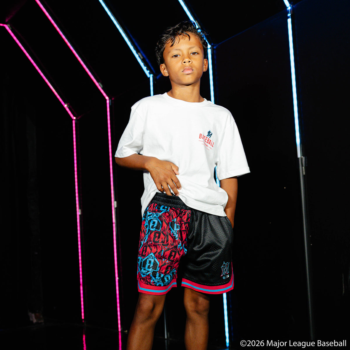 Youth model wearing black youth shorts with "Miami Marlins Sticker Court" design