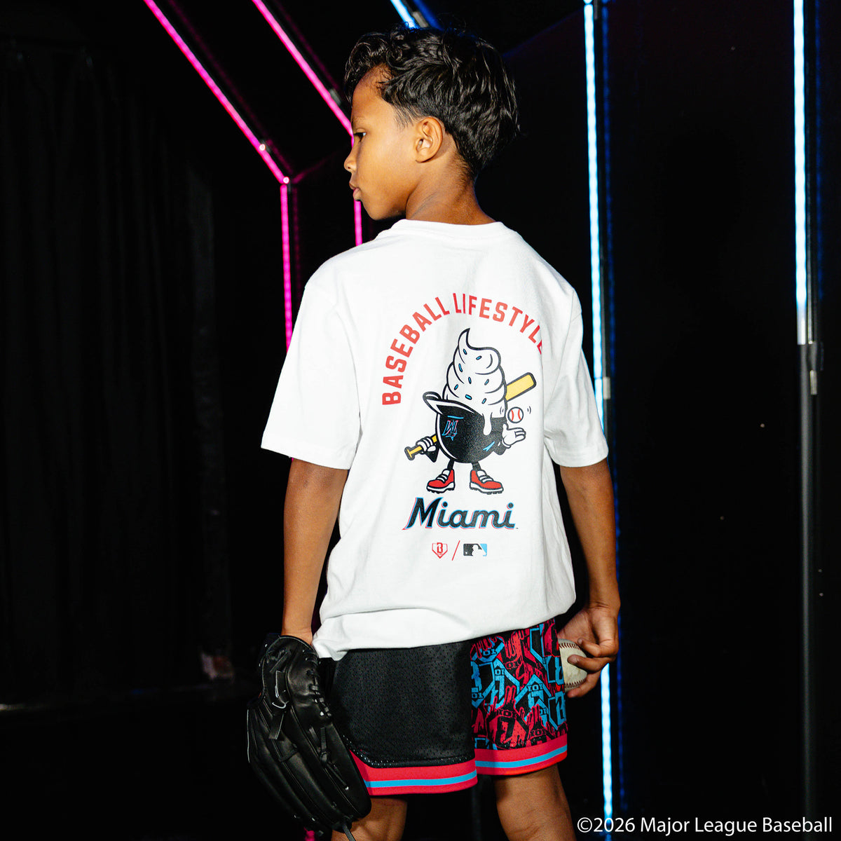 Youth model wearing white youth graphic tee with "Miami Marlins Ice Cream Cap" design