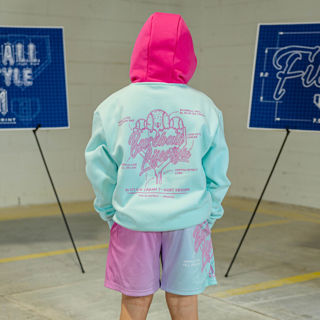 Child in light blue hoodie with pink hood and pink BL101 Ice cream logo