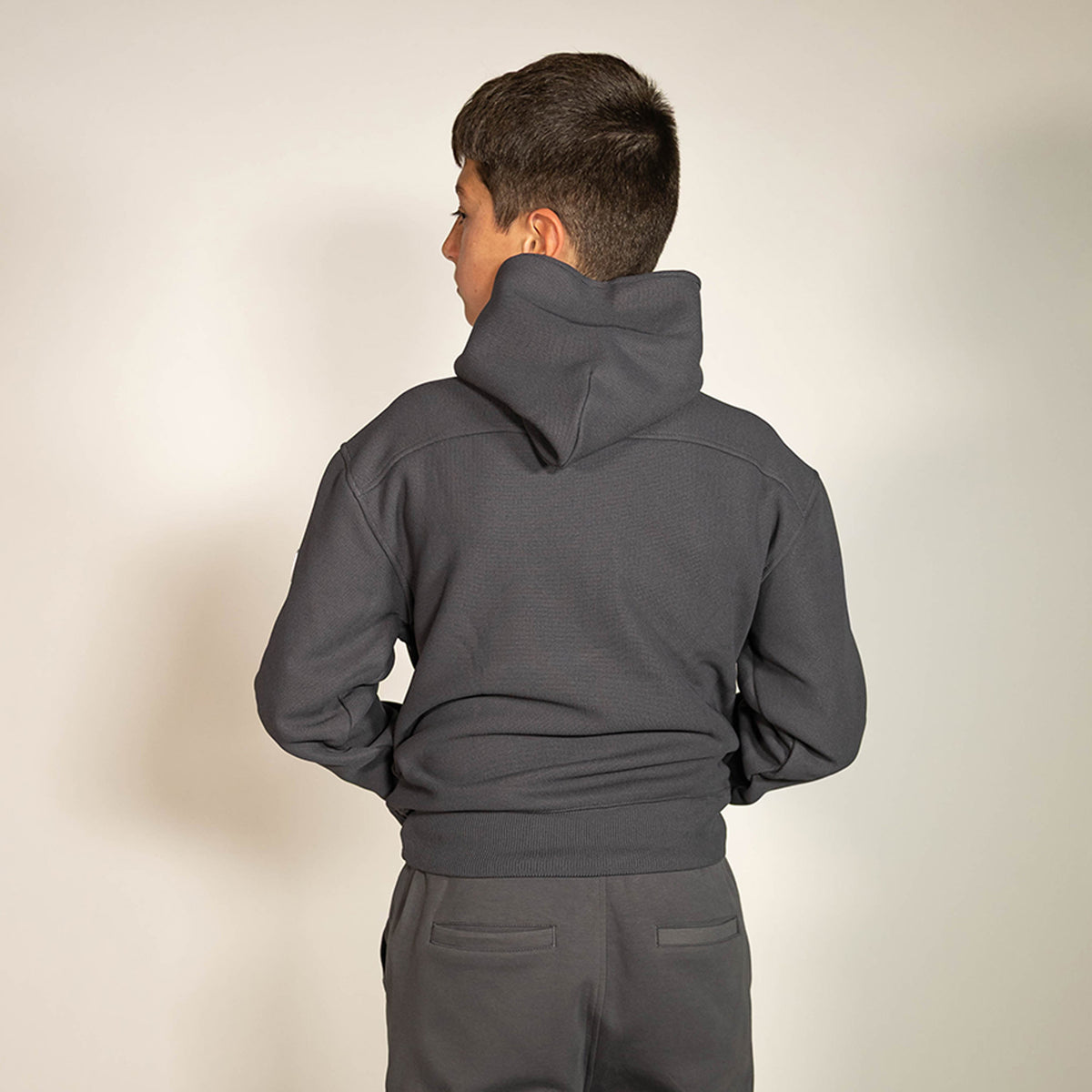Youth model wearing gray and lilac Off-Field Waffle Performance youth hoodie