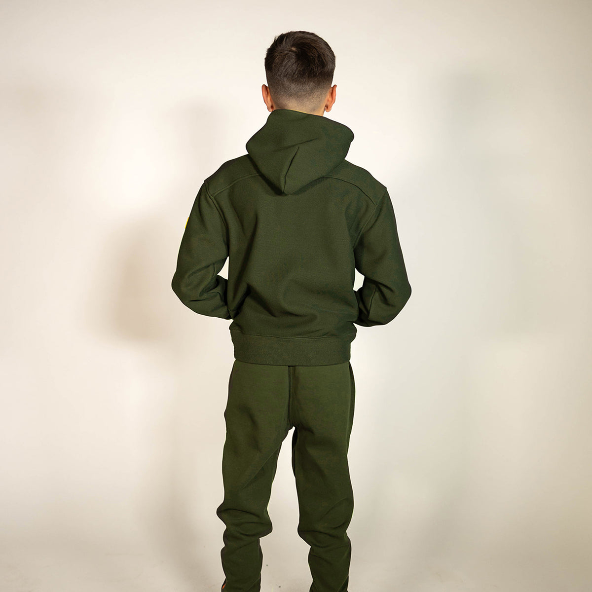 Youth model wearing green Realtree Legacy Off-Field Waffle Performance Camo youth hoodie