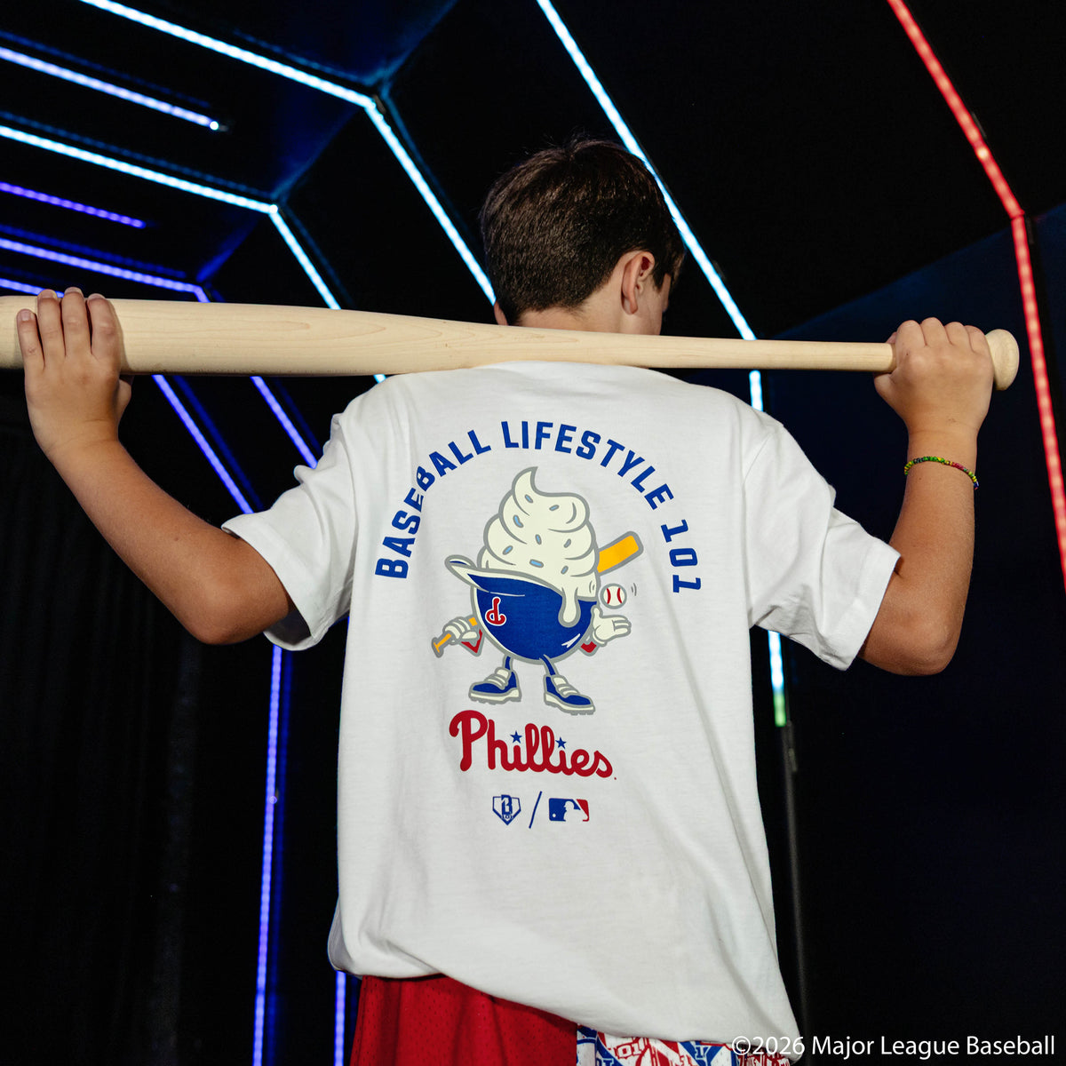 Youth model wearing white youth graphic tee with "Philadelphia Phillies Ice Cream Cap" design