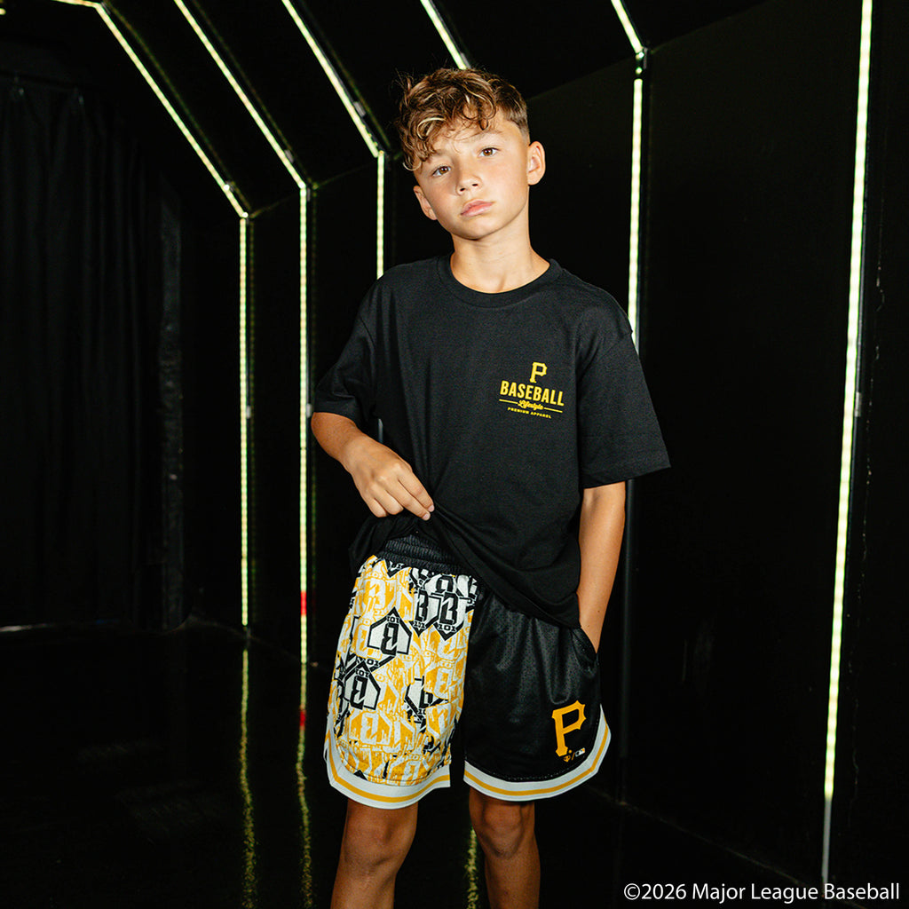 Youth model wearing black youth shorts with "Pittsburgh Pirates Sticker Court" design