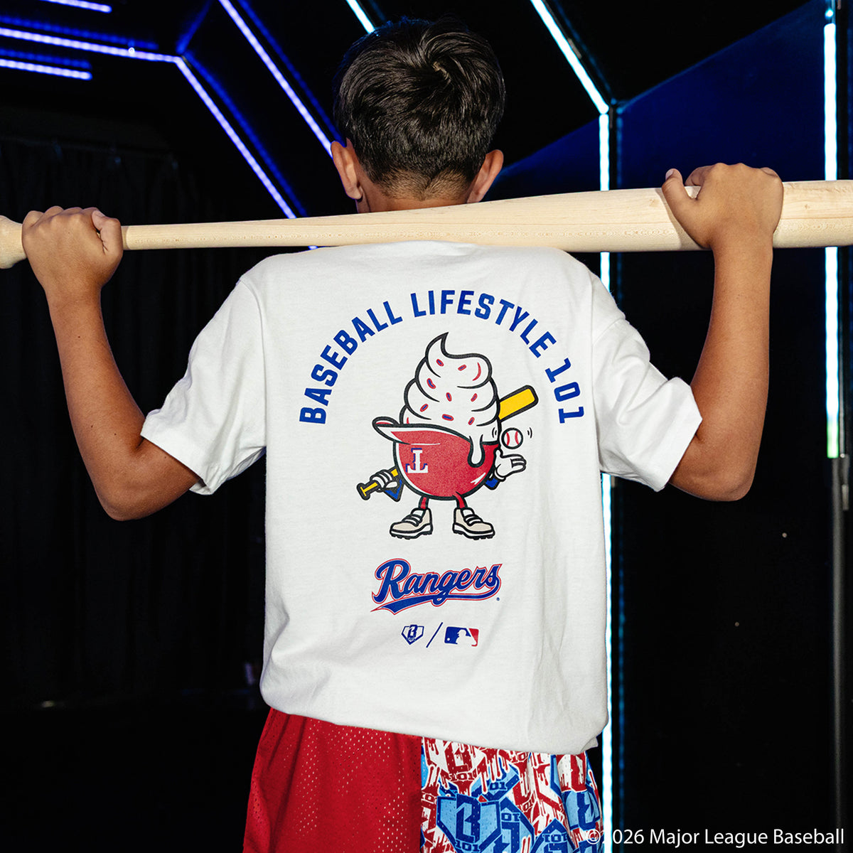 Youth model wearing white youth graphic tee with "Texas Rangers Ice Cream Cap" design
