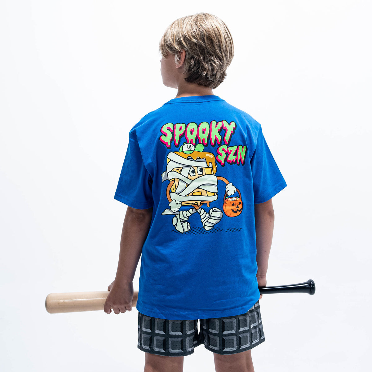 Youth model wearing blue youth graphic tee with "Spooky SZN Waffle" design
