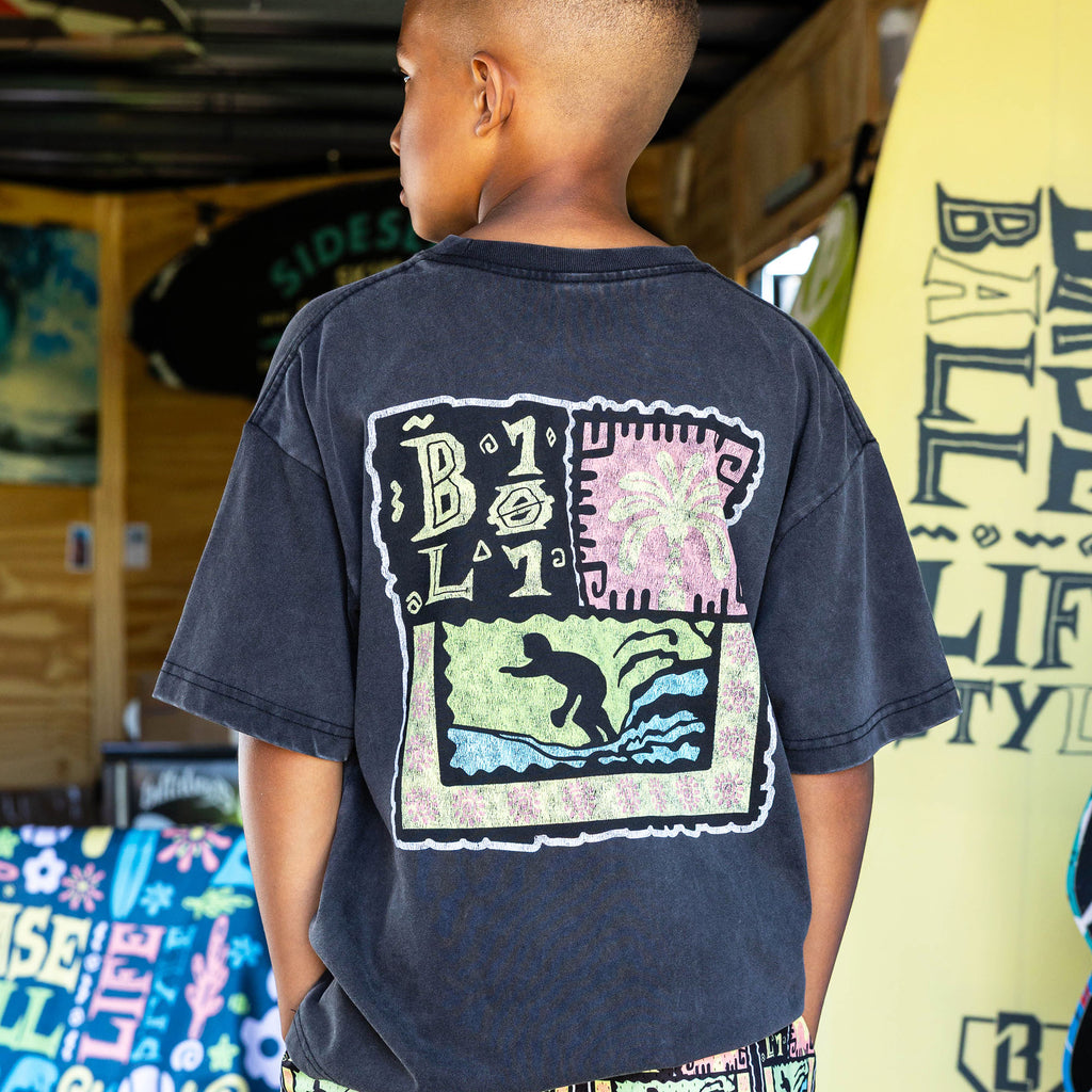 Youth model wearing black youth graphic tee with "Wave Goodbye" design